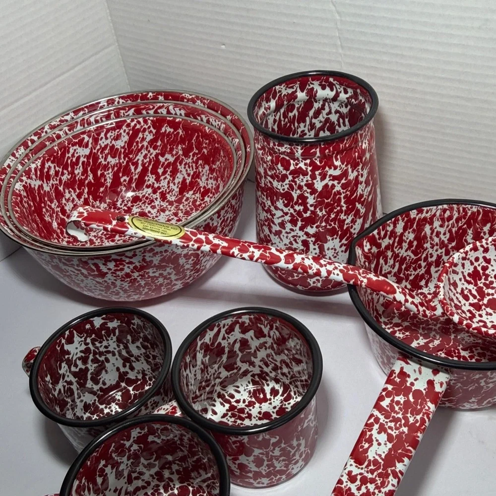 Vintage enameled tableware set with red splashes: rustic kitchen decoration